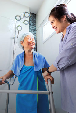 a nurse helping an elderly woman