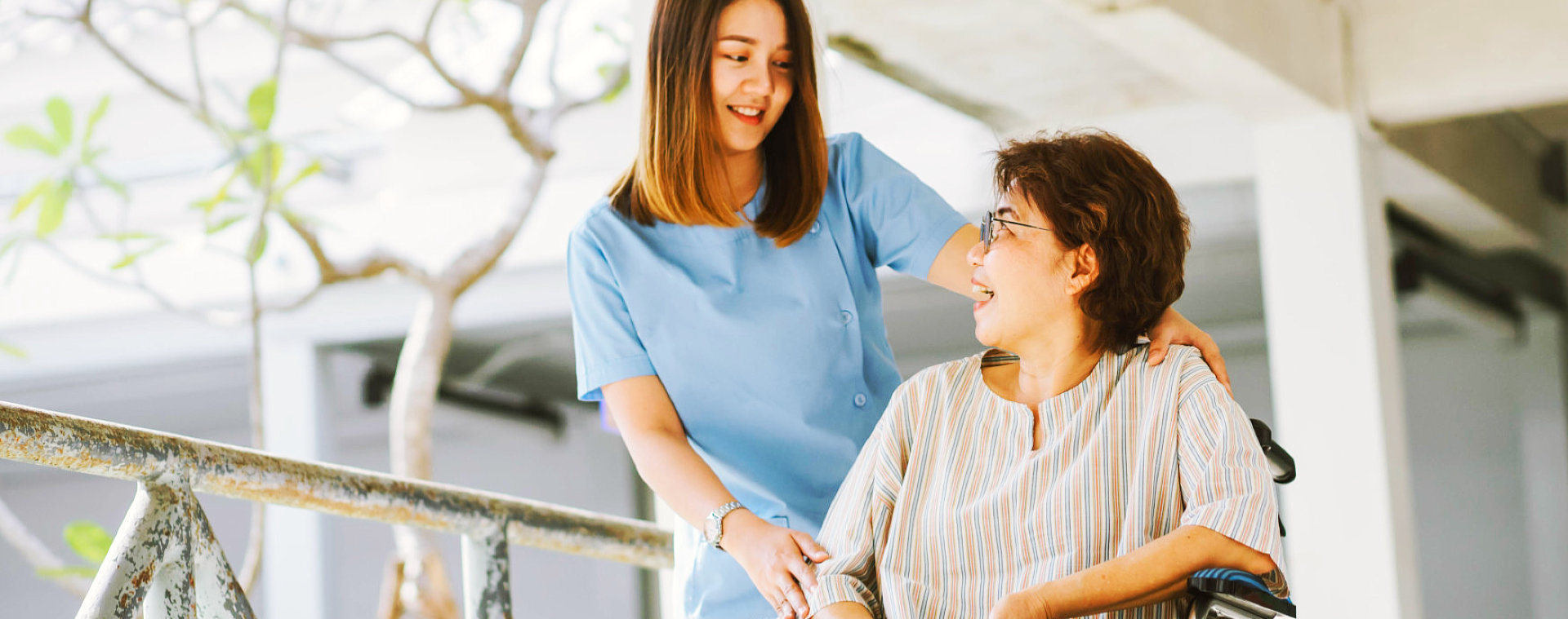 a beautiful caregiver with an elderly woman