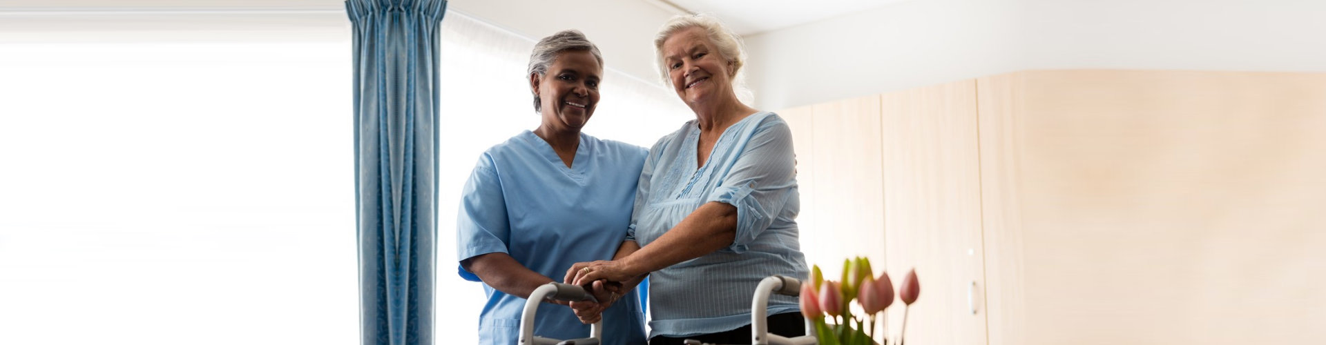 a caregiver woman with an elderly woman standing